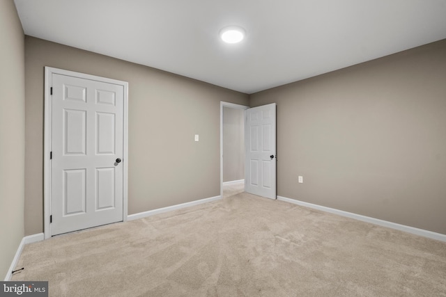 unfurnished bedroom featuring light carpet