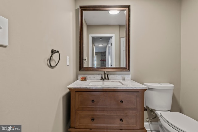 bathroom featuring toilet and vanity