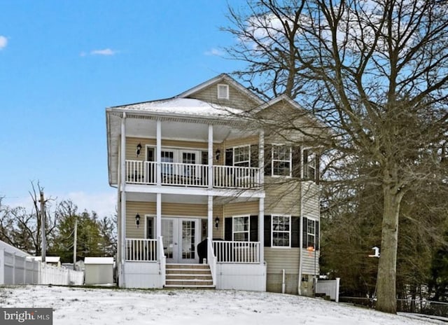 view of front of property featuring french doors and a balcony