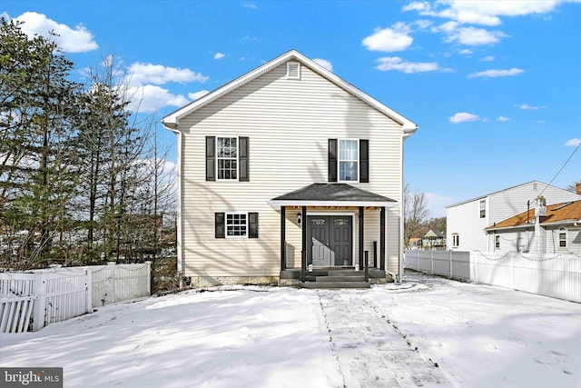 view of snow covered rear of property