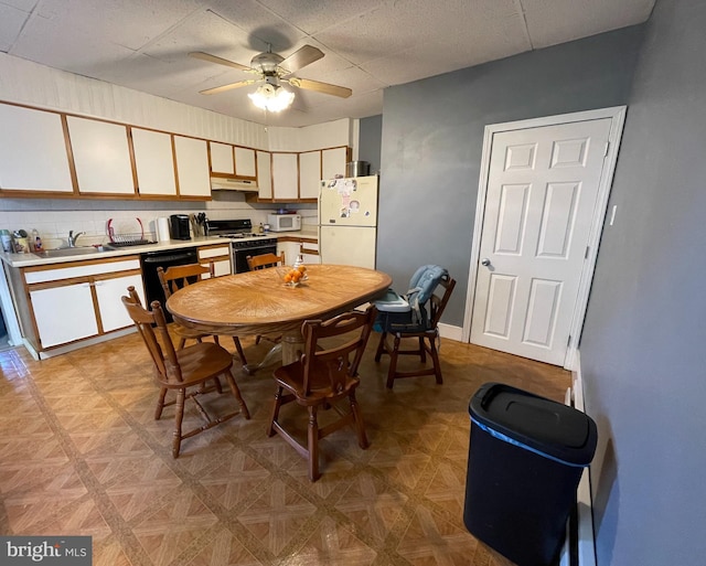 kitchen featuring ceiling fan, sink, white appliances, and light parquet floors