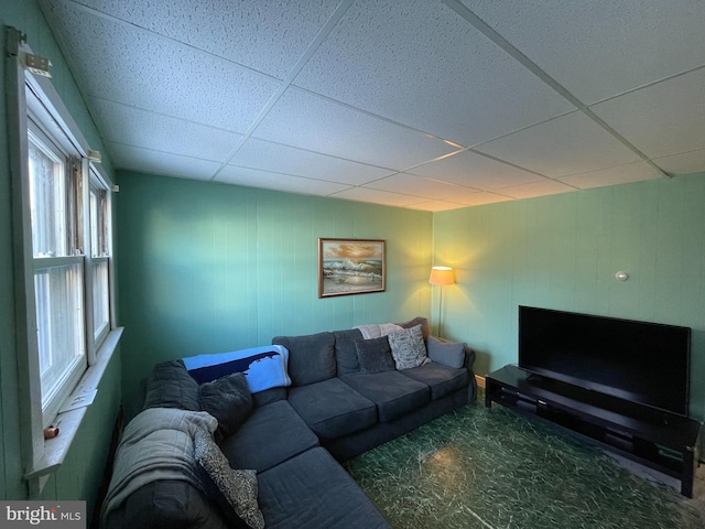 living room with a paneled ceiling