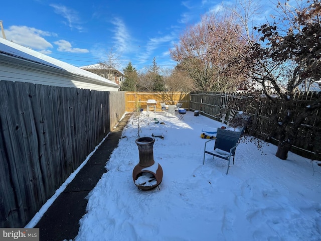 snowy yard featuring a fire pit