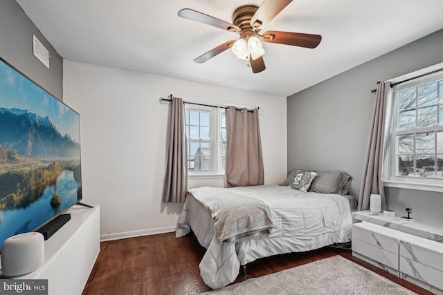 bedroom with ceiling fan and dark hardwood / wood-style flooring