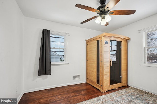 unfurnished bedroom with ceiling fan and dark hardwood / wood-style flooring