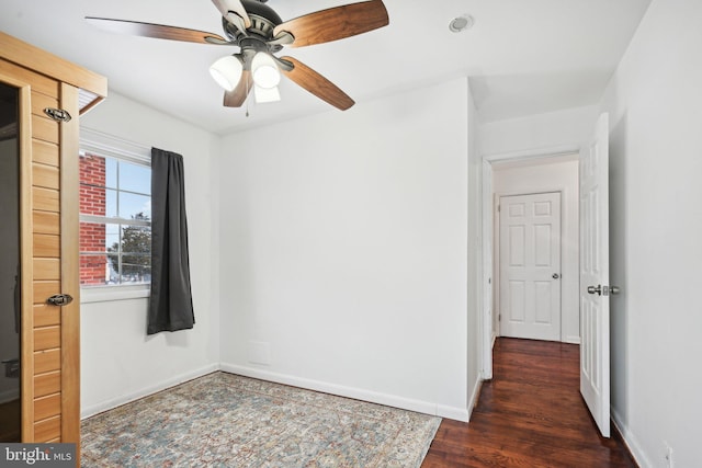 spare room with ceiling fan and dark hardwood / wood-style flooring