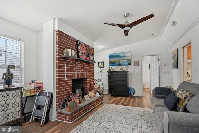 living room featuring crown molding, a fireplace, dark hardwood / wood-style flooring, ceiling fan, and lofted ceiling