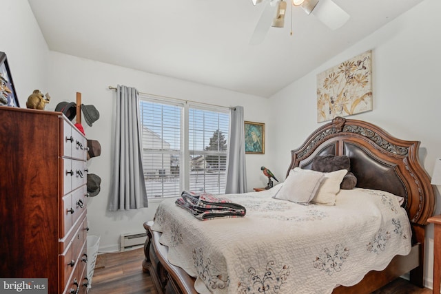 bedroom with dark hardwood / wood-style floors, a baseboard heating unit, and ceiling fan