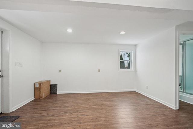 empty room with dark hardwood / wood-style flooring