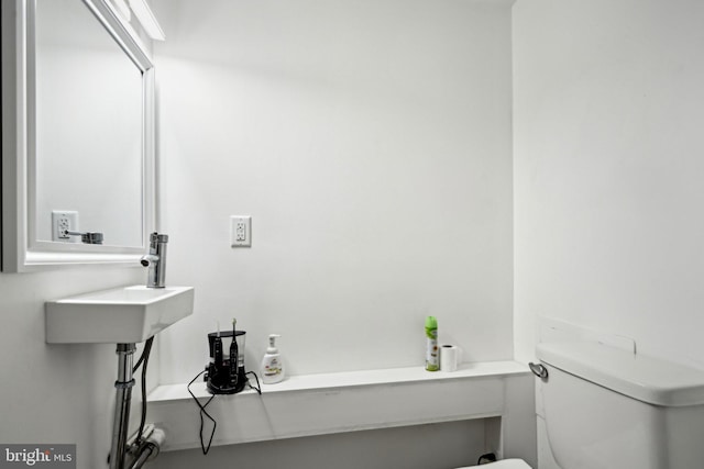 bathroom featuring sink and toilet