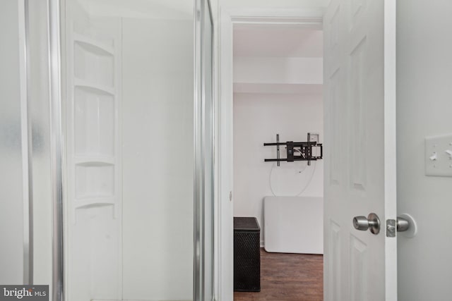 bathroom with hardwood / wood-style flooring and a shower