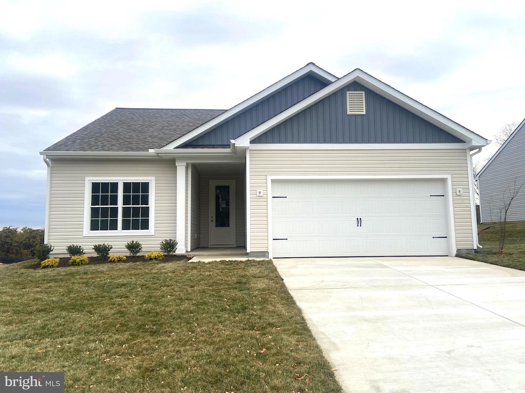 view of front of property with a front lawn and a garage