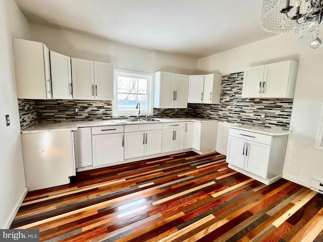 kitchen with decorative backsplash, sink, and white cabinetry