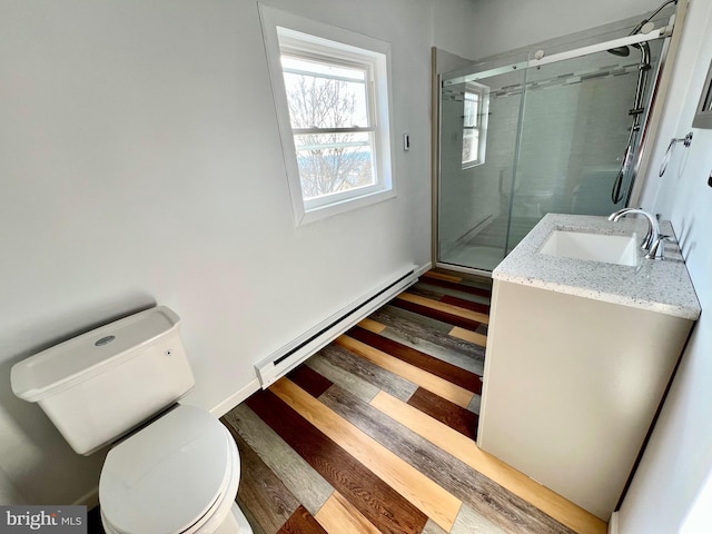 bathroom featuring an enclosed shower, vanity, toilet, and a baseboard radiator