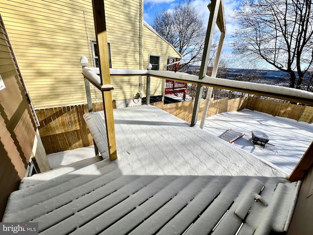 snow covered deck featuring a fire pit