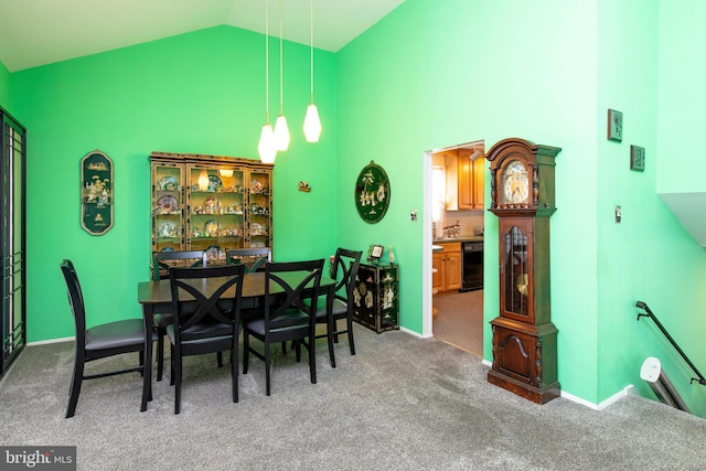 dining space with carpet floors and vaulted ceiling