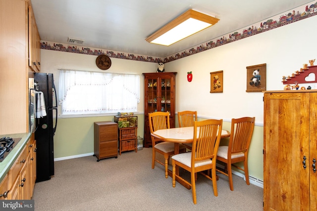 dining room with light carpet