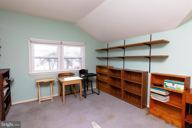 carpeted office space featuring lofted ceiling