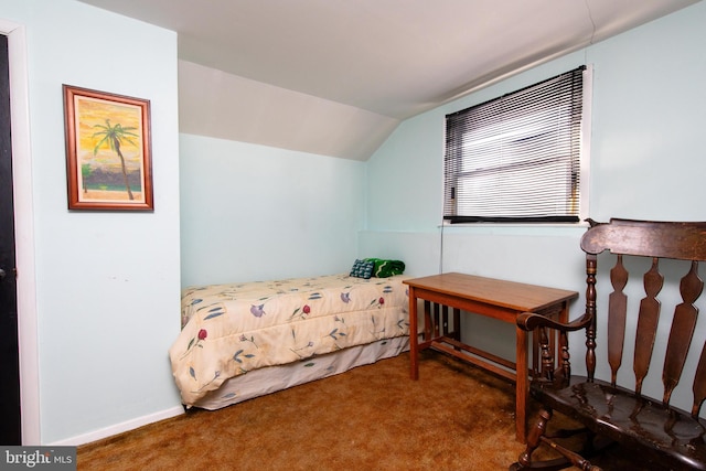 bedroom featuring lofted ceiling and dark colored carpet