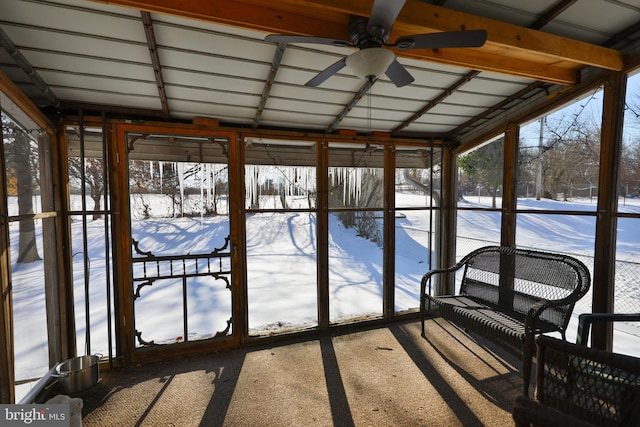 unfurnished sunroom featuring ceiling fan