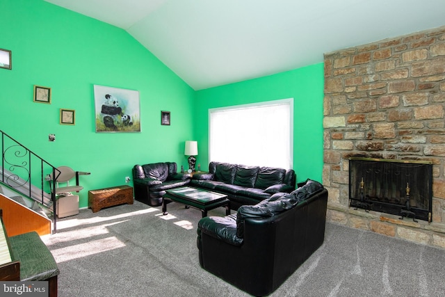 living room featuring carpet floors, lofted ceiling, and a stone fireplace