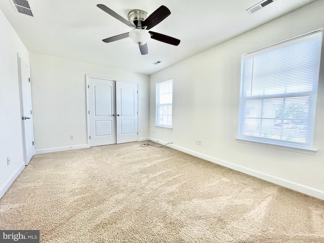 unfurnished bedroom featuring carpet flooring, a closet, and ceiling fan