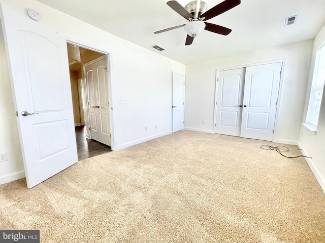 unfurnished bedroom with ceiling fan, a closet, and carpet flooring