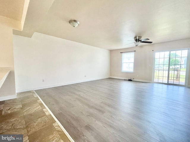 empty room featuring ceiling fan and hardwood / wood-style flooring