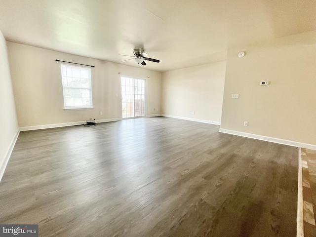 spare room with ceiling fan and dark hardwood / wood-style flooring