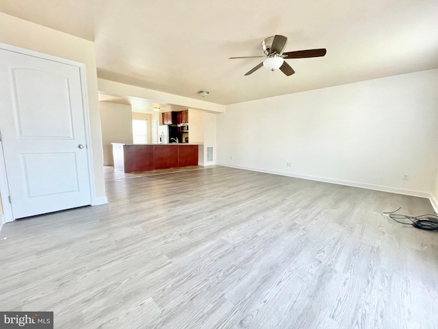 unfurnished living room with light hardwood / wood-style floors and ceiling fan