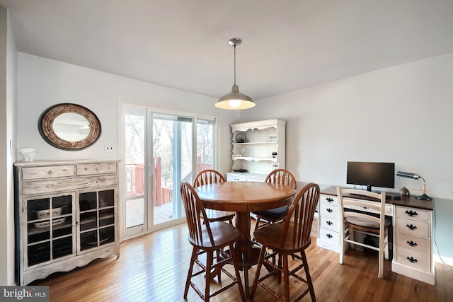 dining space with wood-type flooring