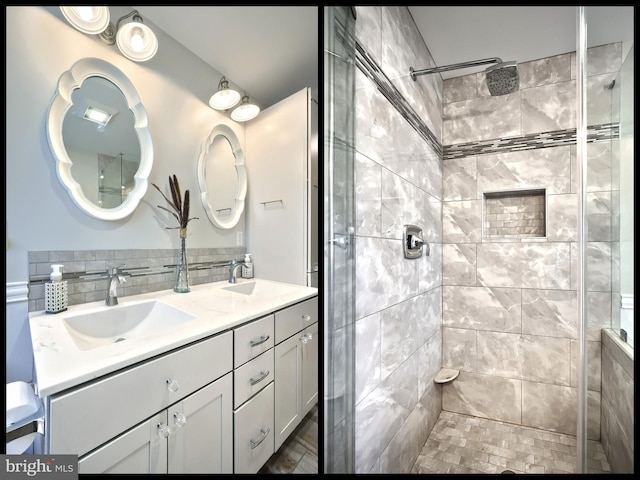 bathroom with double vanity, decorative backsplash, a shower stall, and a sink