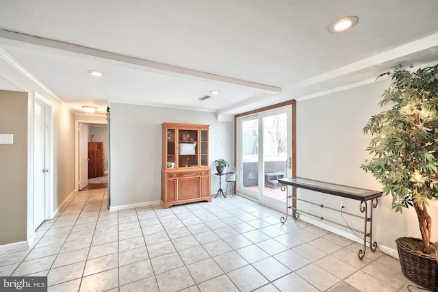 foyer entrance with beamed ceiling, light tile patterned floors, recessed lighting, and baseboards