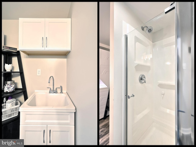 bathroom featuring vanity, wood finished floors, and a shower stall