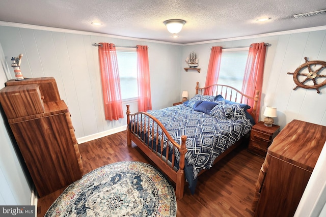 bedroom with visible vents, multiple windows, a textured ceiling, and wood finished floors