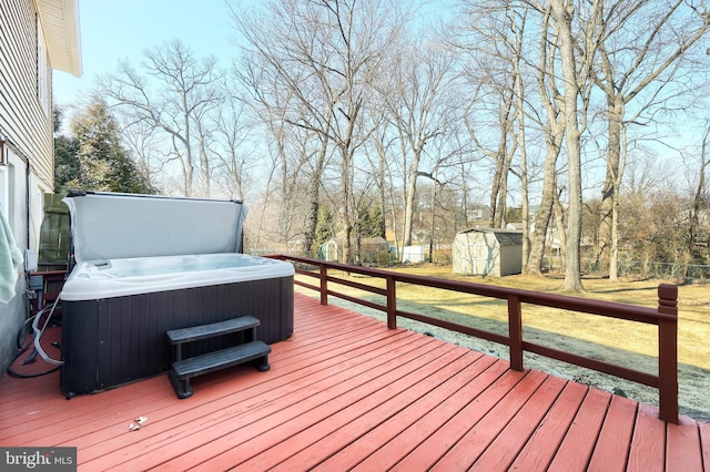 wooden terrace with an outbuilding, a fenced backyard, a shed, central AC unit, and a hot tub