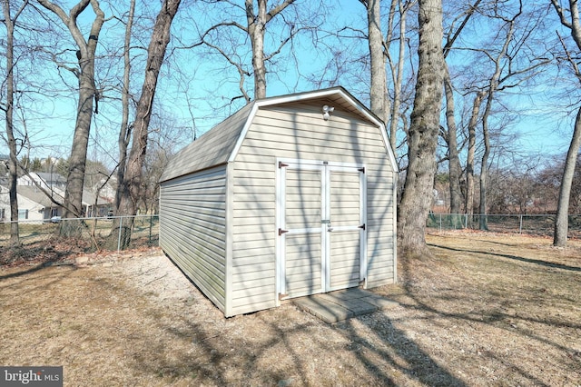 view of shed featuring fence