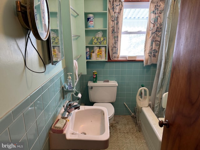 full bathroom with toilet, shower / tub combo, tile walls, and sink