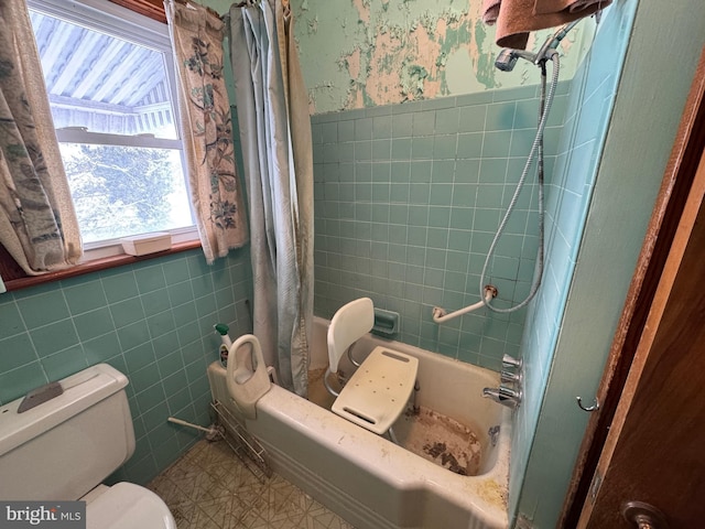 bathroom with toilet, shower / bathtub combination with curtain, and tile walls