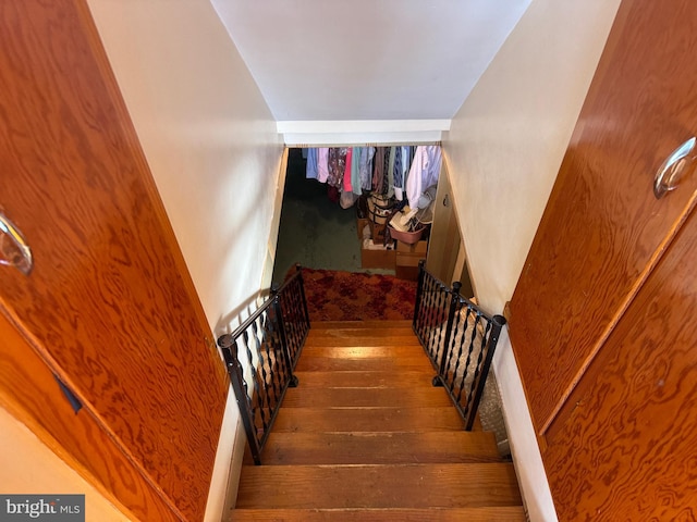 stairs featuring hardwood / wood-style floors