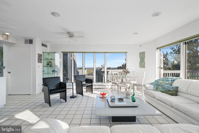 living room featuring light tile patterned floors and ceiling fan