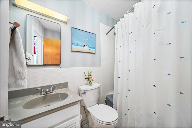 full bathroom featuring toilet, a textured ceiling, tile walls, vanity, and shower / bath combo with shower curtain