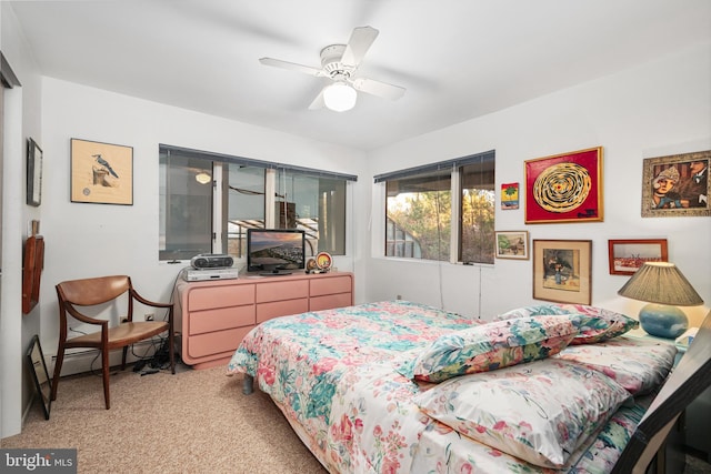 carpeted bedroom featuring a baseboard radiator and ceiling fan