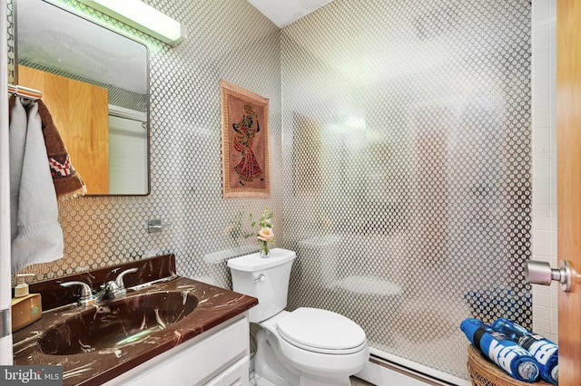 bathroom featuring a baseboard radiator, vanity, and toilet