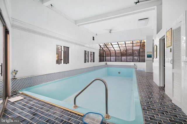 view of swimming pool with a lanai and ceiling fan