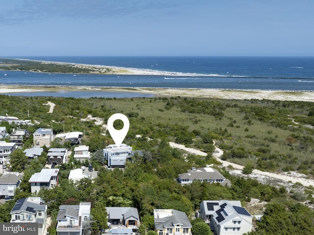 bird's eye view with a water view and a beach view