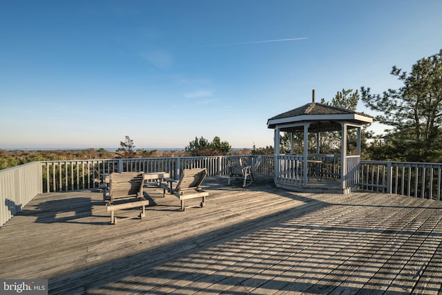 wooden terrace featuring a gazebo