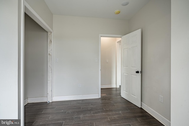 unfurnished bedroom with dark hardwood / wood-style floors