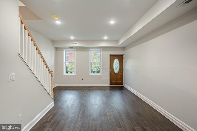 entryway with dark hardwood / wood-style flooring