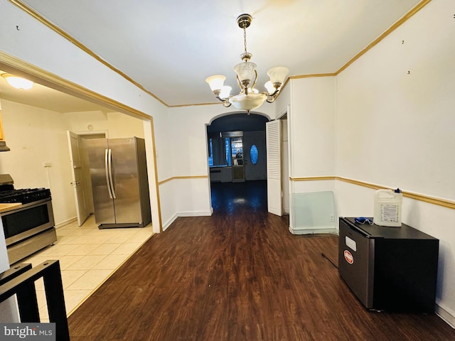 dining space featuring an inviting chandelier, crown molding, and wood-type flooring